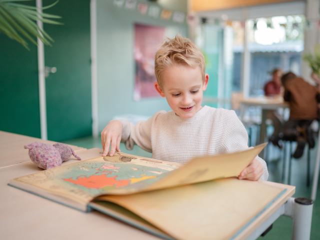 Jongen leest in Atlas